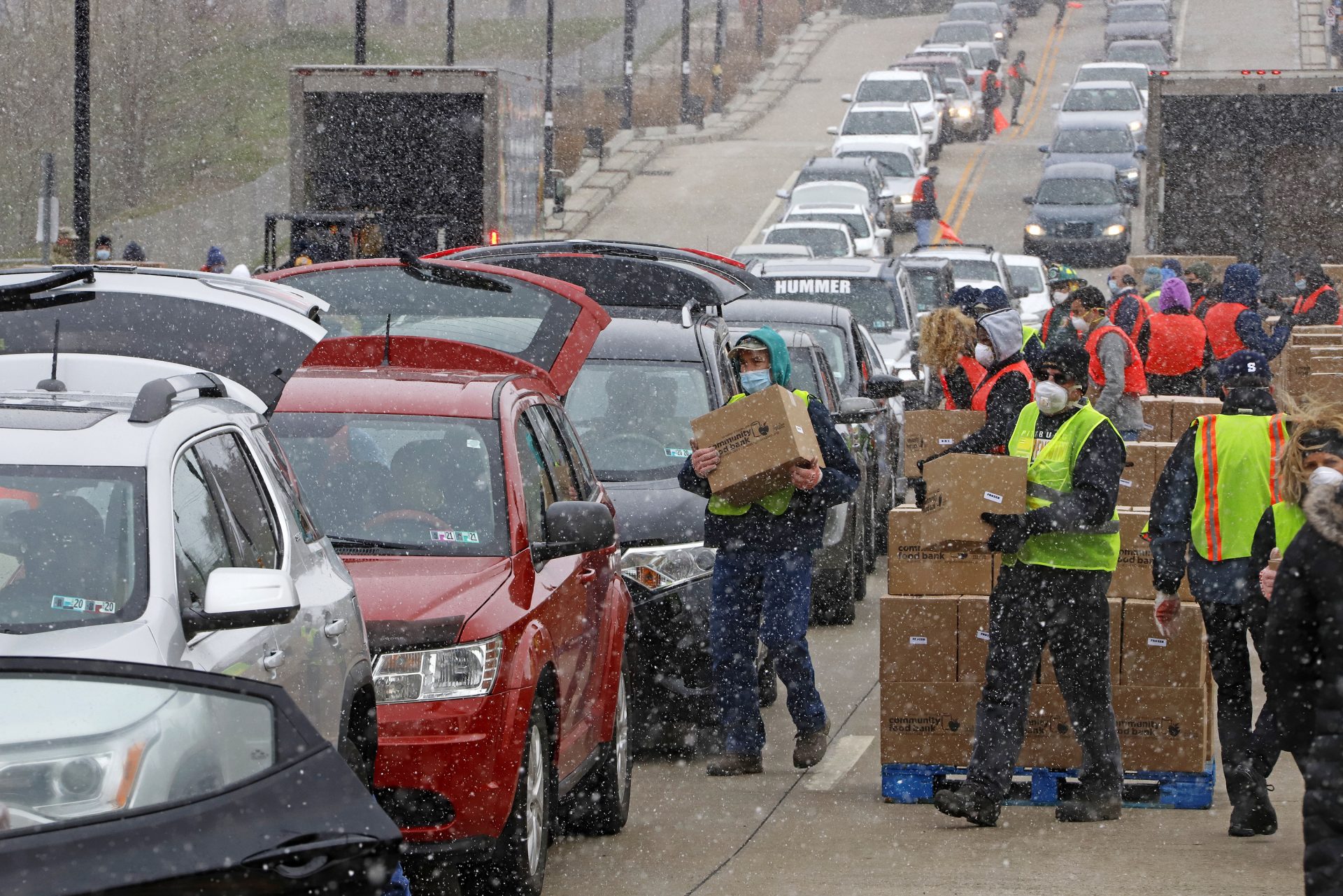 FILE PHOTO: Boxes of food are distributed by the Greater Pittsburgh Community Food Bank, at a drive thru distribution near PPG Arena in downtown Pittsburgh, Friday, April 10, 2020.