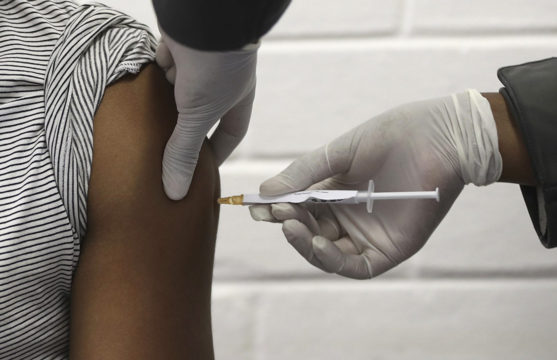 A volunteer receives an injection developed at the University of Oxford as part of a COVID-19 vaccine trial at the Chris Hani Baragwanath hospital in Soweto, Johannesburg Wednesday, June 24, 2020.
