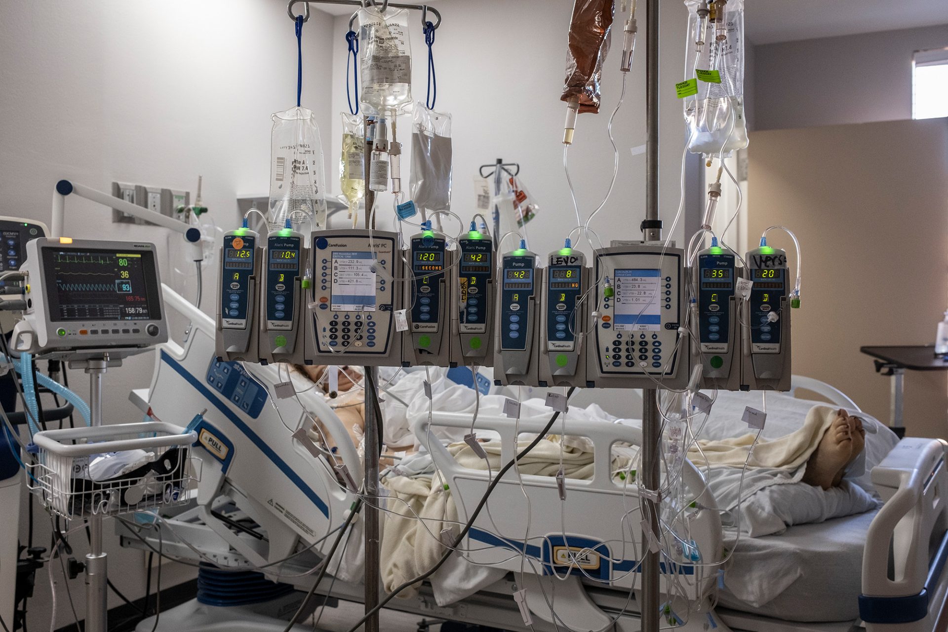 IV pumps and electrocardiogram machines are seen in a patient's room in the COVID-19 intensive care unit at the United Memorial Medical Center on Dec. 7 in Houston.