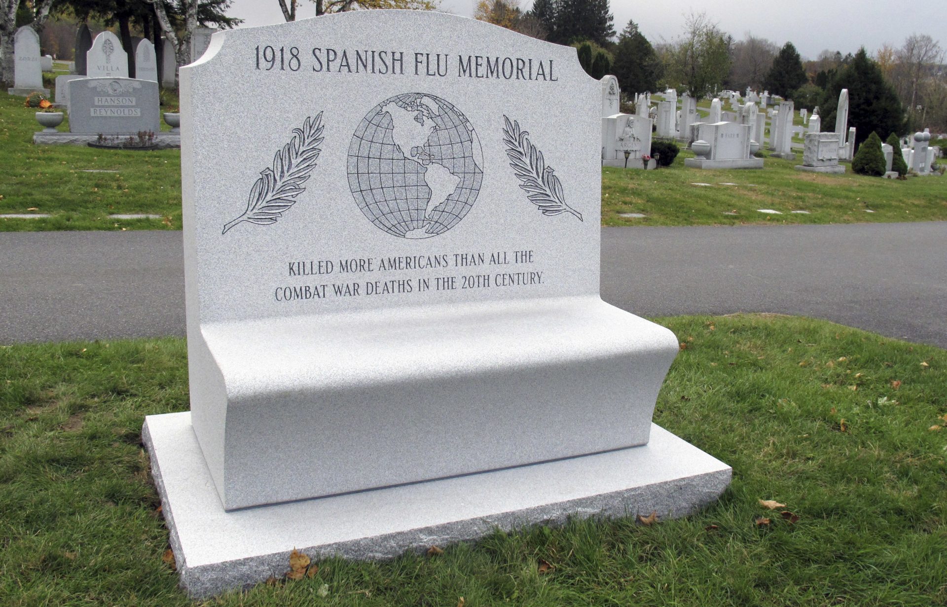 This Tuesday, Oct. 23, 2018, photo shows a memorial to victims of the Spanish flu at the Hope Cemetery in Barre, Vt. Brian Zecchinelli installed the monument to commemorate his grandfather, killed when the flu swept the state in the fall of 1918. It is estimated the flu killed 50 million people worldwide.