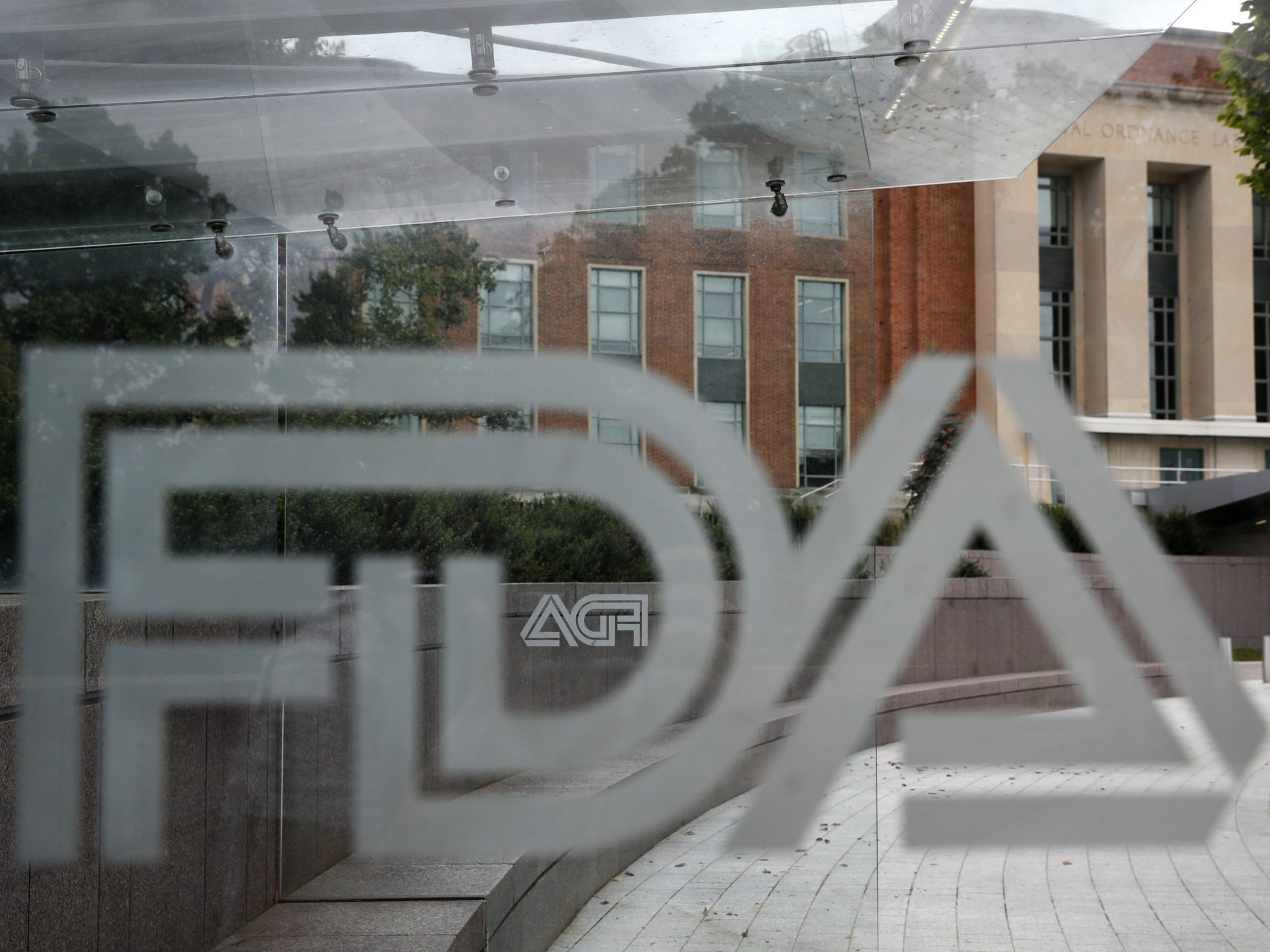 FILE PHOTO: This Thursday, Aug. 2, 2018, file photo shows the U.S. Food and Drug Administration building behind FDA logos at a bus stop on the agency's campus in Silver Spring, Md.