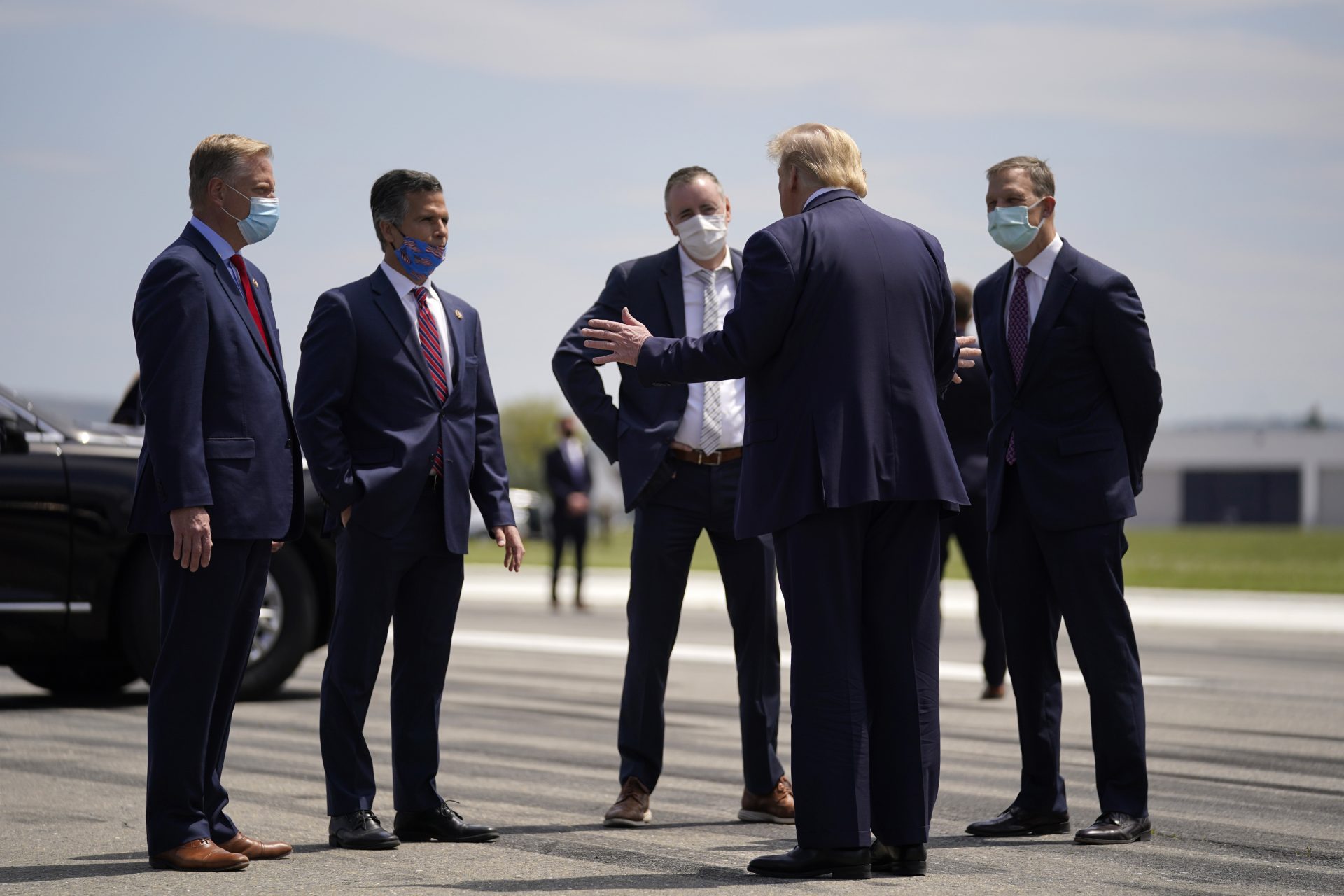 FILE PHOTO: President Donald Trump, second from right, speaks with from left, Rep. Fred Keller, Rep. Dan Meuser, Rep. Brian Fitzpatrick, Rep. Scott Perry after arriving at Lehigh Valley International Airport in Allentown, Pa., Thursday, May 14, 2020.