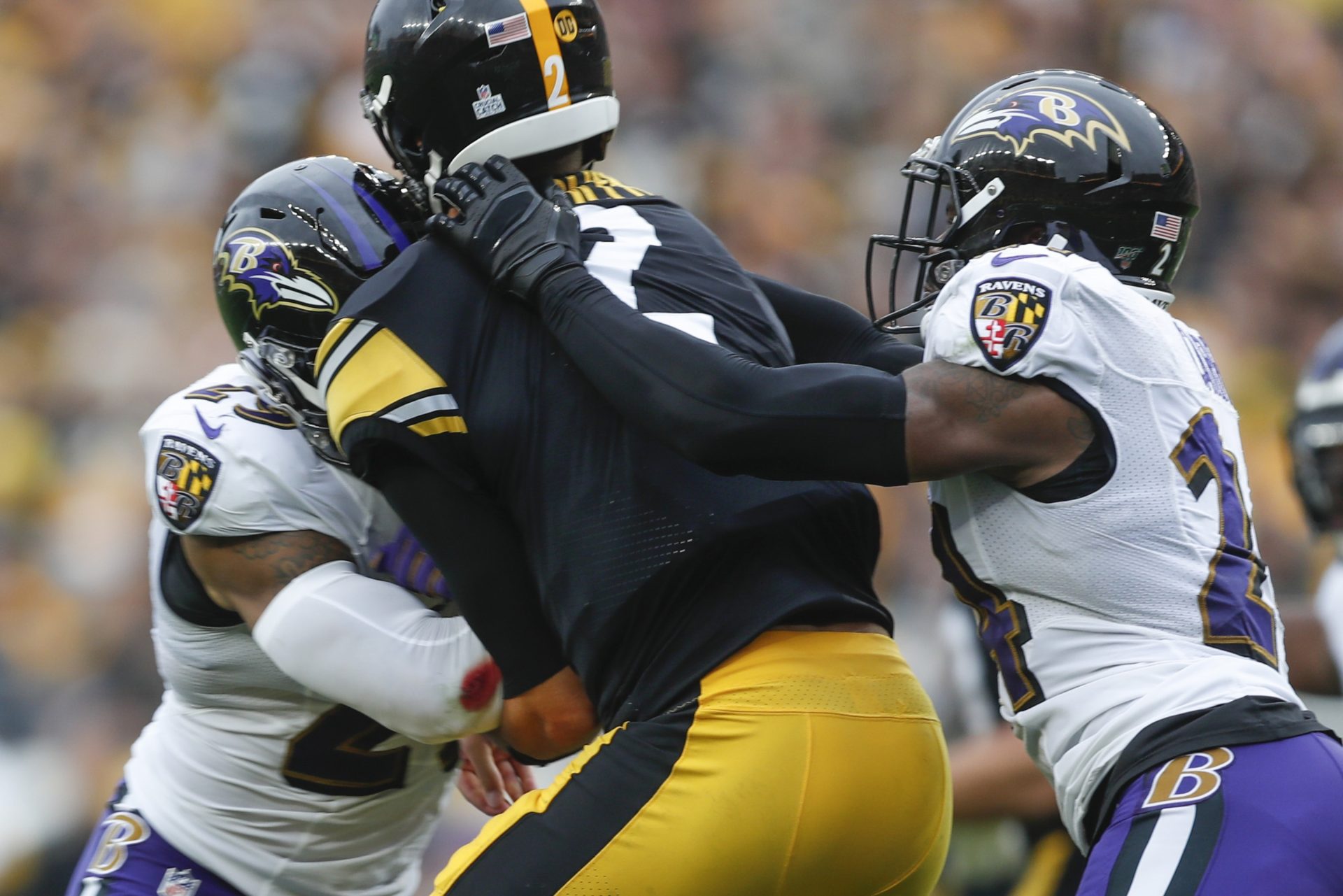 Pittsburgh Steelers quarterback Mason Rudolph (2) is hit by Baltimore Ravens free safety Earl Thomas (29), left, and cornerback Brandon Carr (24) during the second half of an NFL football game, Sunday, Oct. 6, 2019, in Pittsburgh.