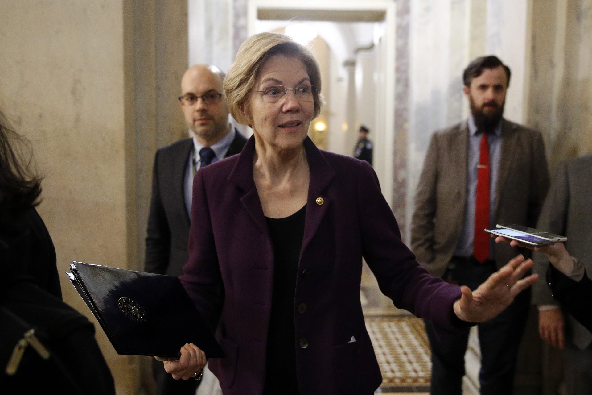 Sen. Elizabeth Warren, D-Mass., speaks with reporters as she departs at the end of the day in the impeachment trial of President Donald Trump on charges of abuse of power and obstruction of Congress on Capitol Hill in Washington, Wednesday, Jan. 29, 2020.