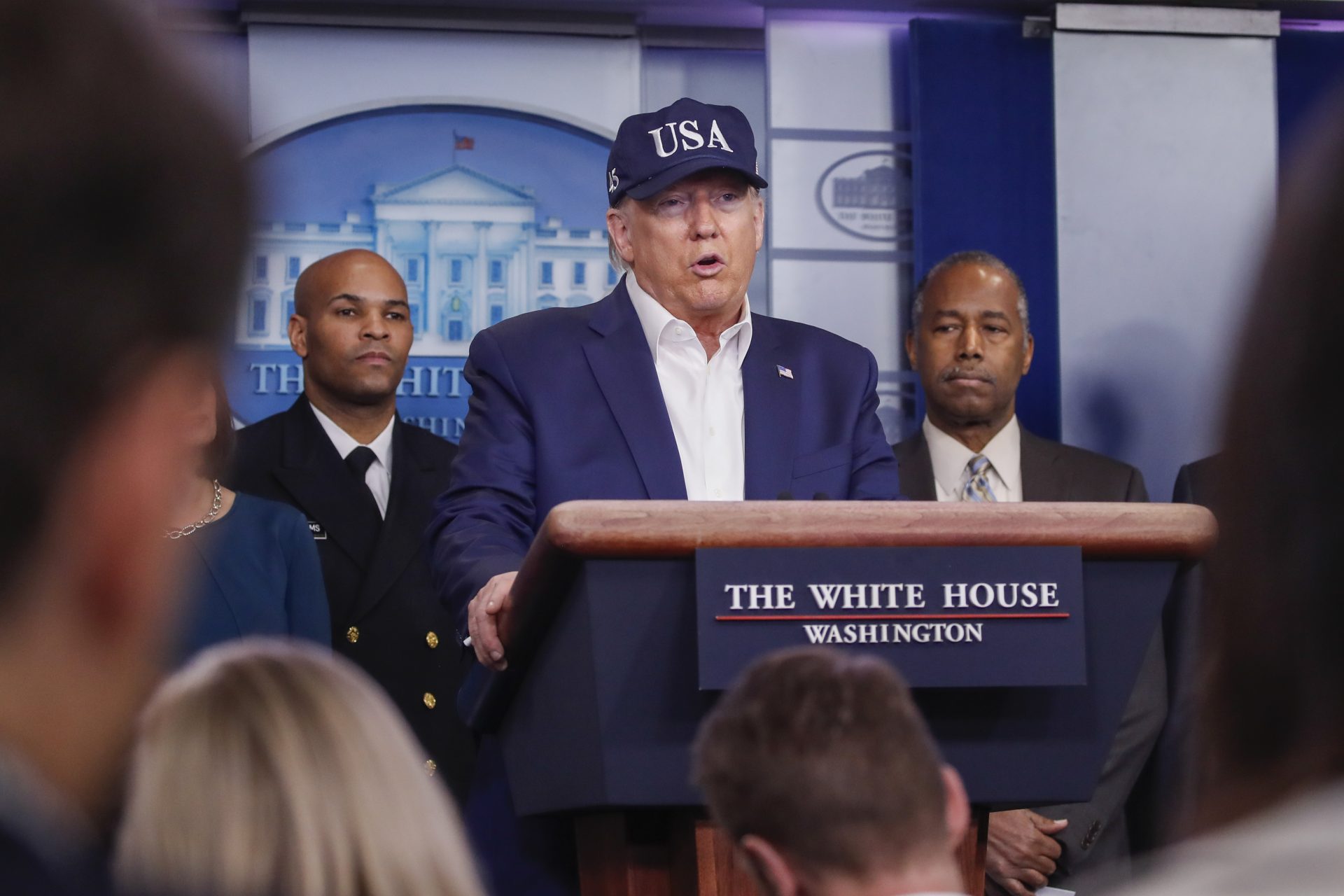 President Donald Trump speaks during a briefing on coronavirus in the Brady press briefing room at the White House, Saturday, March 14, 2020, in Washington, as U.S. Surgeon General Jerome Adams and Housing and Urban Development Secretary Ben Carson listen.