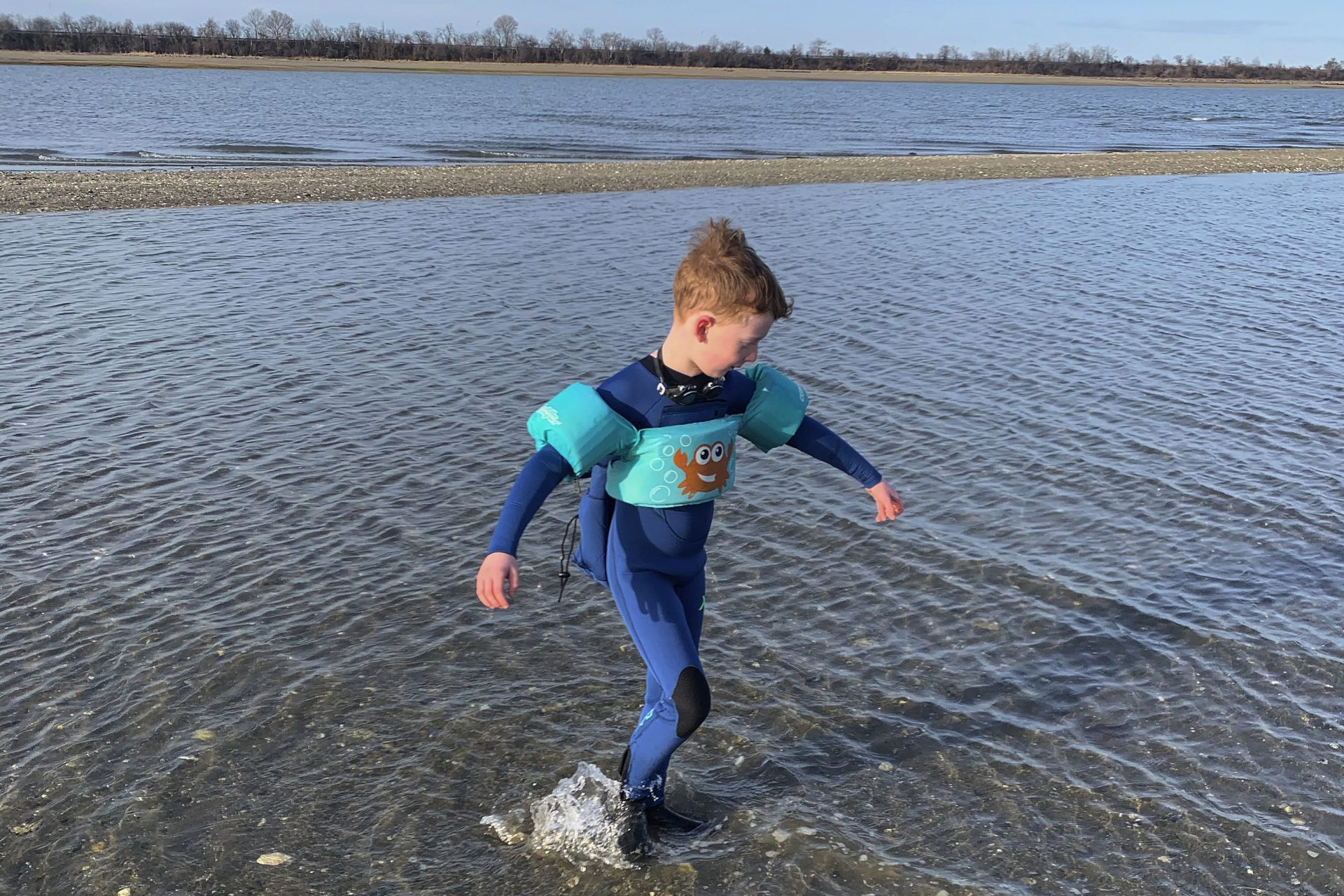 This March 18, 2020, photo released by Alexandra Nicholson shows her son, Henry Martinsen, playing at a beach in Quincy, Mass. The frustration of parents is mounting as more families across the U.S. enter their second or even third week of total distance learning, and some say it will be their last.