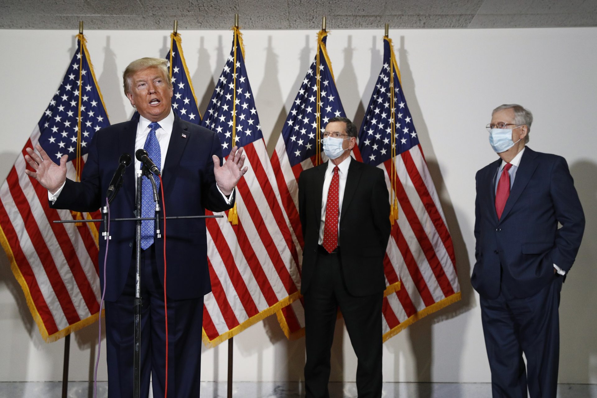 President Trump speaks to reporters May 19 after meeting with Senate Republicans at their weekly luncheon on Capitol Hill. Sen. John Barrasso, R-Wyo., and Senate Majority Leader Mitch McConnell stand behind Trump.