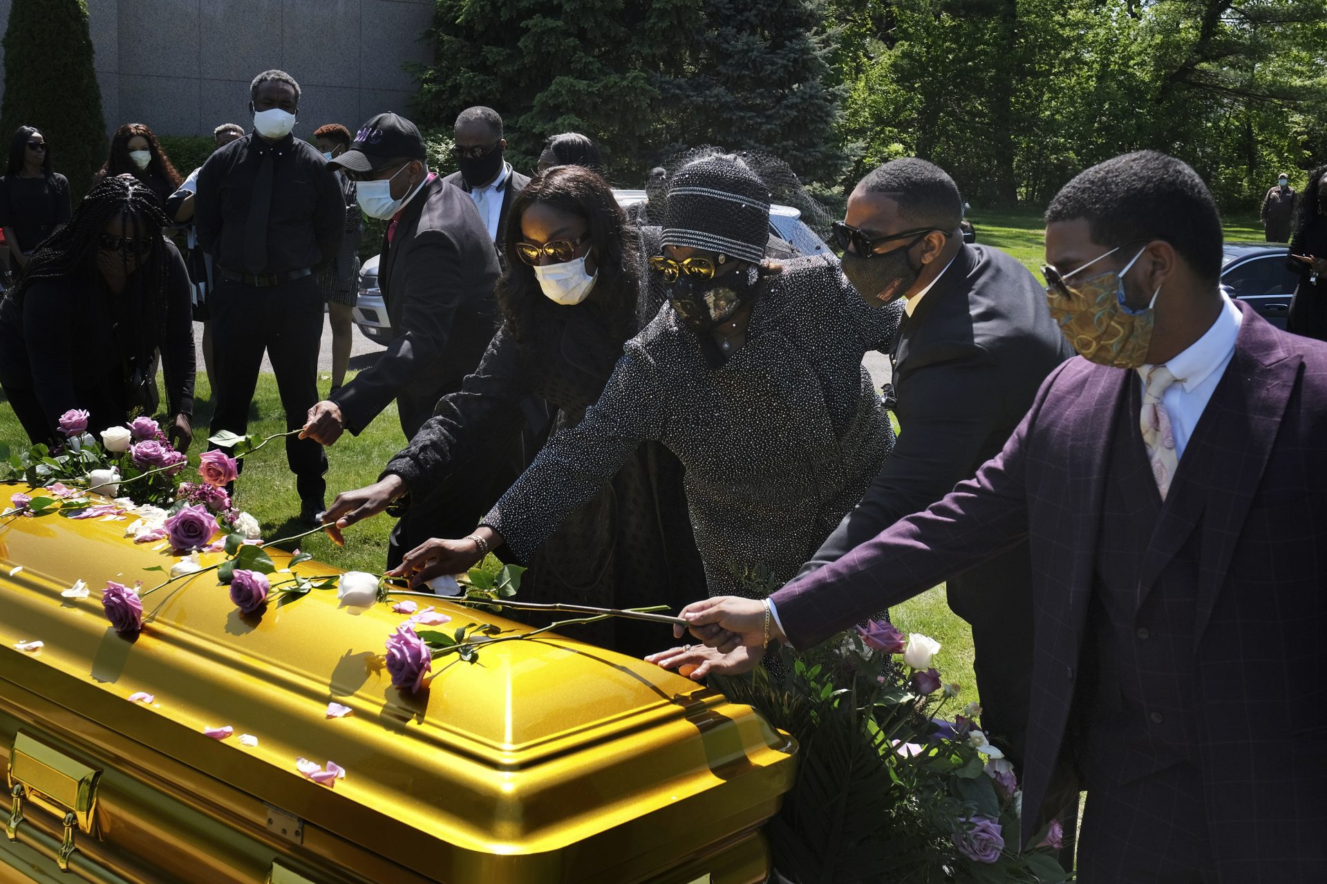 Family and friends lay flowers on the casket of Bishop Carl Williams Jr. last week at Hollywood Memorial Park and Cemetery in Union, N.J. Only a few family members were permitted to attend the service in person due to the pandemic.