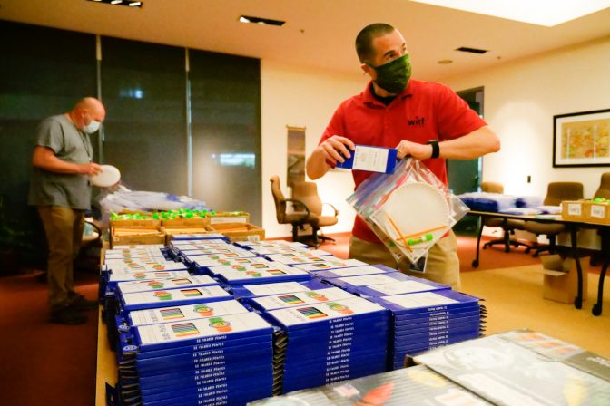 WITF President & CEO Ron Hetrick helps to assemble the 3,000 Grab and Go bags for the Summer STEM Adventure program. WITF set up assembly lines in two large areas of the Public Media Center where social distancing and mask wearing were mandatory.