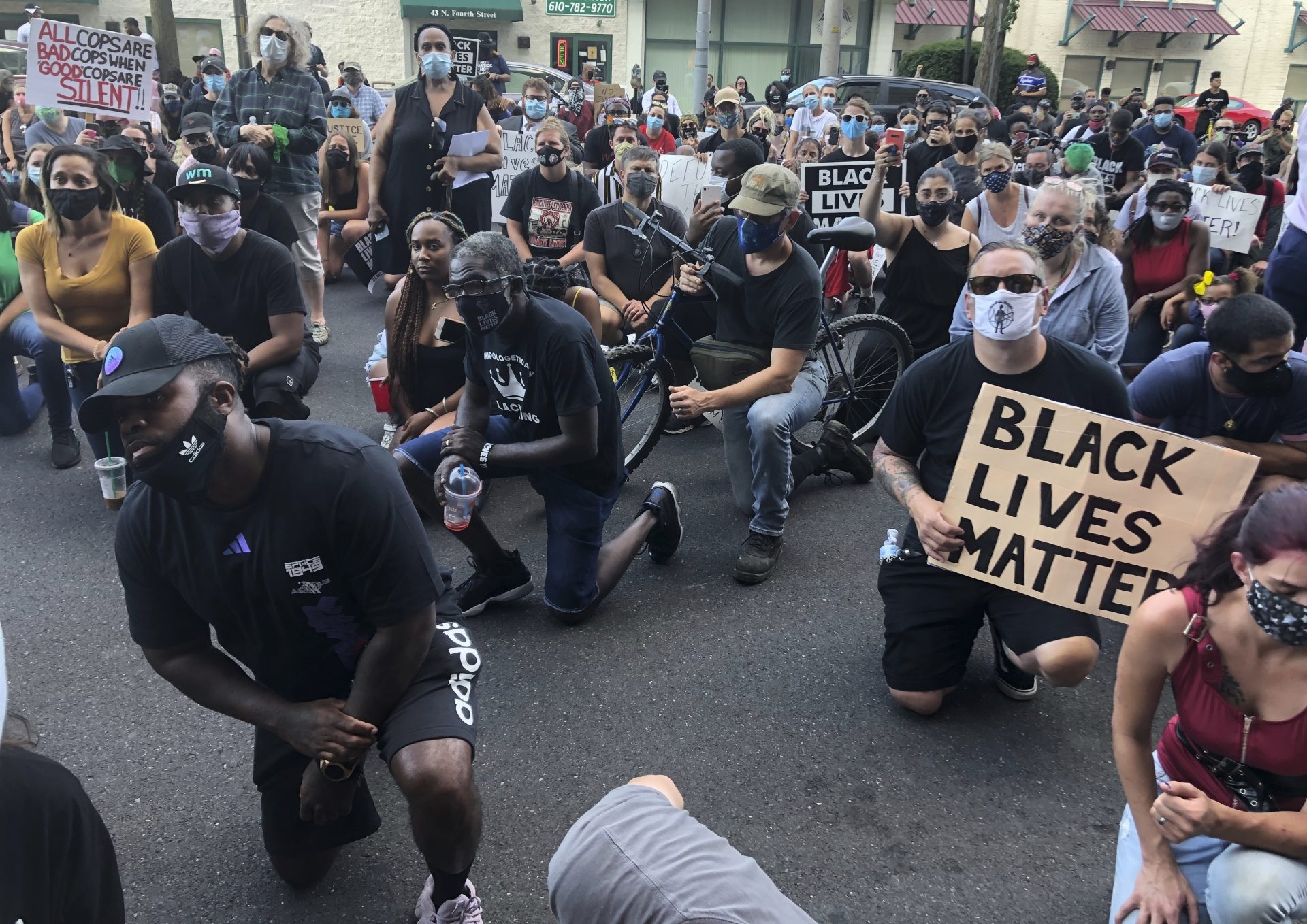 Protesters kneel in front of the Lehigh County Jail in Allentown, Pa., on Monday, July 13, 2020, to demonstrate against police brutality after video emerged of an officer placing his knee on a man's head and neck area outside a city hospital. Police have launched an internal probe.