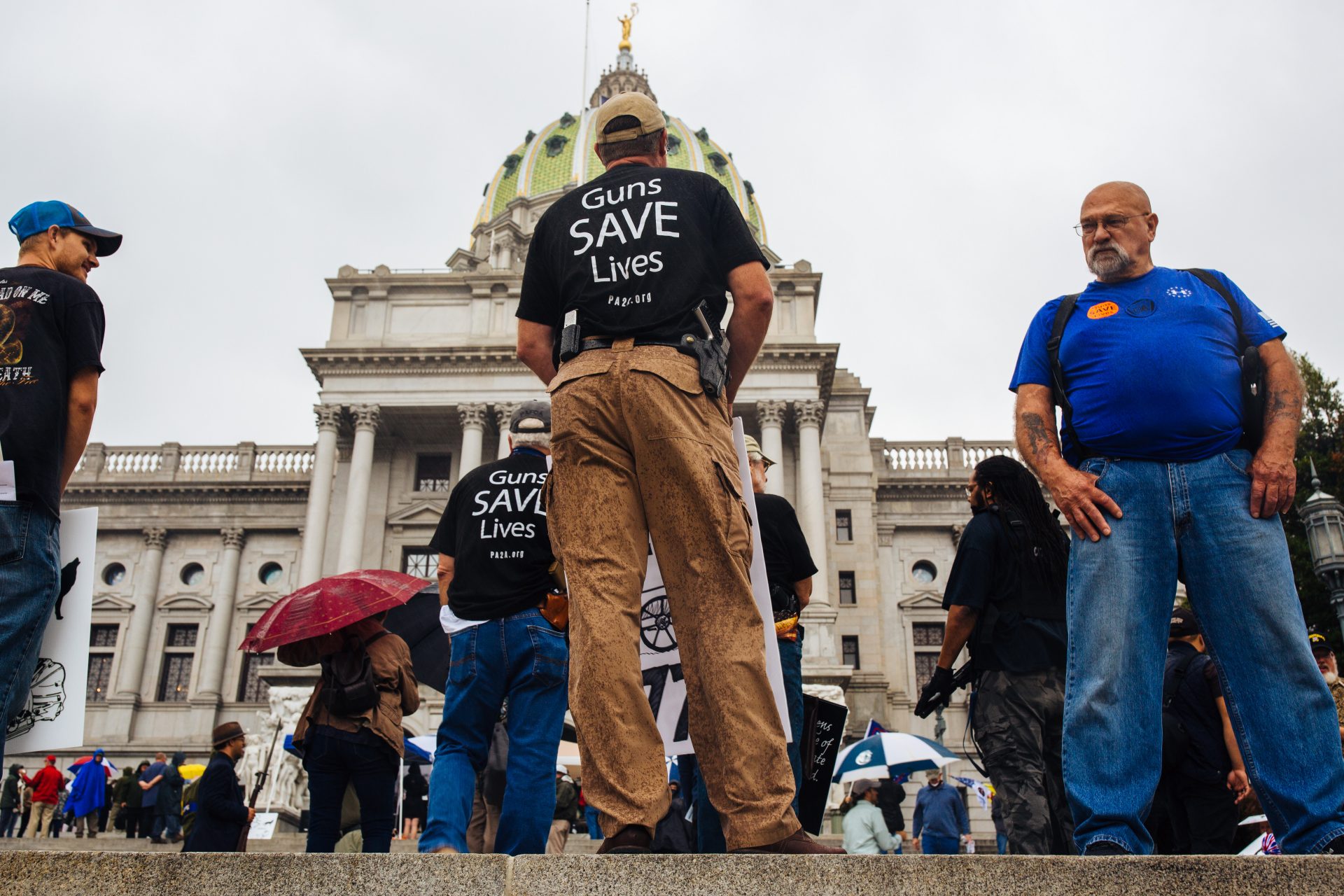 2nd Amendment Rally attendees carry guns and signs on the Capitol steps in Harrisburg, Pa., on September 29, 2020.