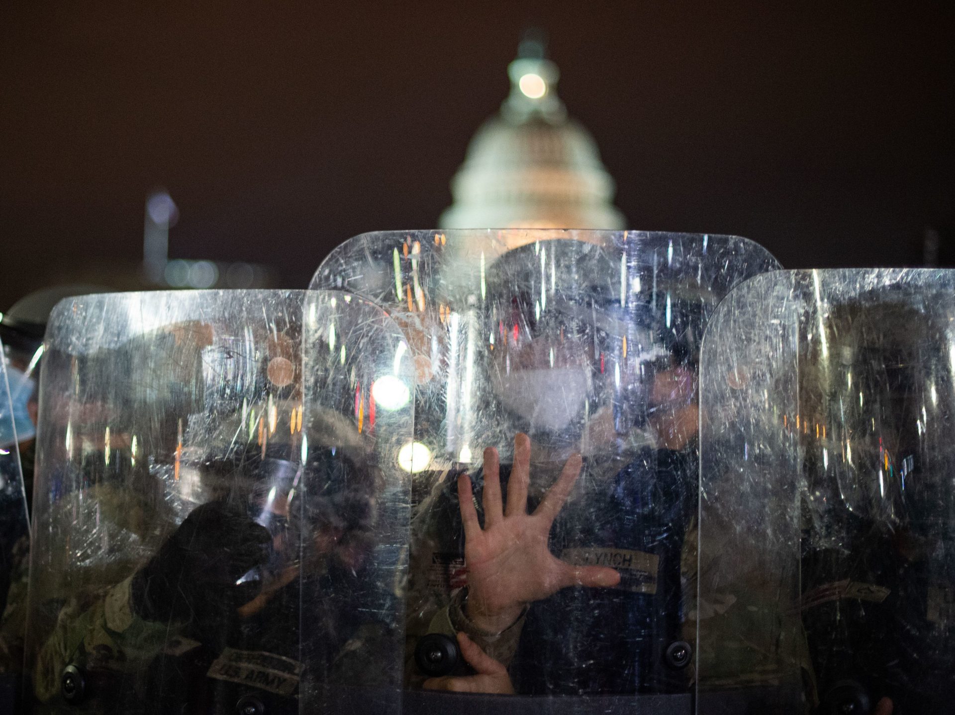 National Guard troops are seen behind shields as they clear a street from protestors outside the Capitol building on January 6, 2021 in Washington, DC.