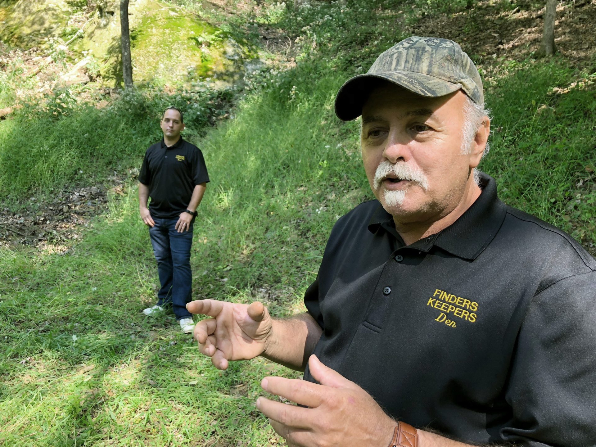 FILE PHOTO: This Sept. 20, 2018 file photo, Dennis Parada, right, and his son Kem Parada stand at the site of the FBI's dig for Civil War-era gold in Dents Run, Pennsylvania. Government emails released under court order show that FBI agents were looking for gold when they excavated Dent's Run in 2018, though the FBI says that nothing was found.