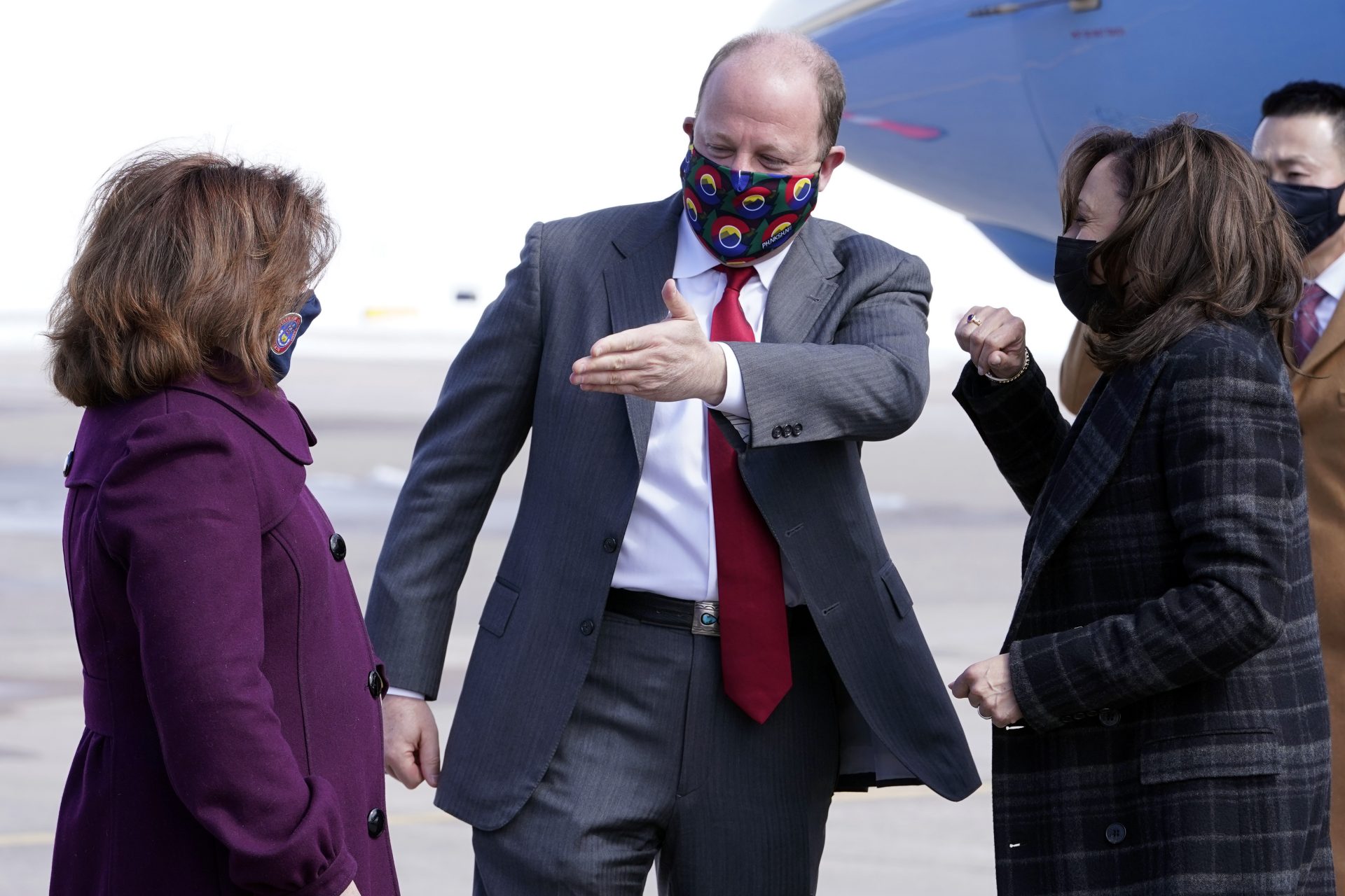 Vice President Kamala Harris are greeted by Colorado Gov. Jared Polis and Colorado Lt. Gov. Dianne Primavera on arrival in Denver, Tuesday March 16, 2021.