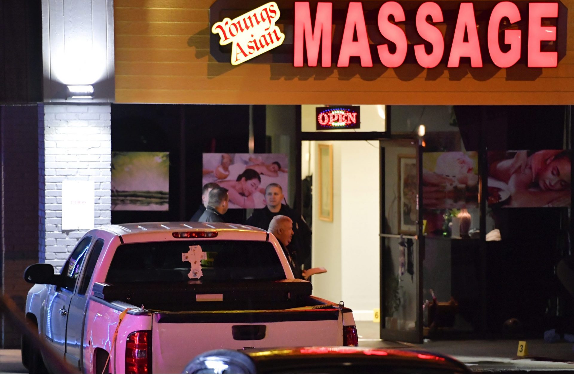 Authorities investigate a fatal shooting at a massage parlor, late Tuesday, March 16, 2021, in Acworth, Ga. Officials say 21-year-old Robert Aaron Long, of Woodstock, Georgia, has been captured hours after multiple people were killed in shootings at three Atlanta-area massage parlors.