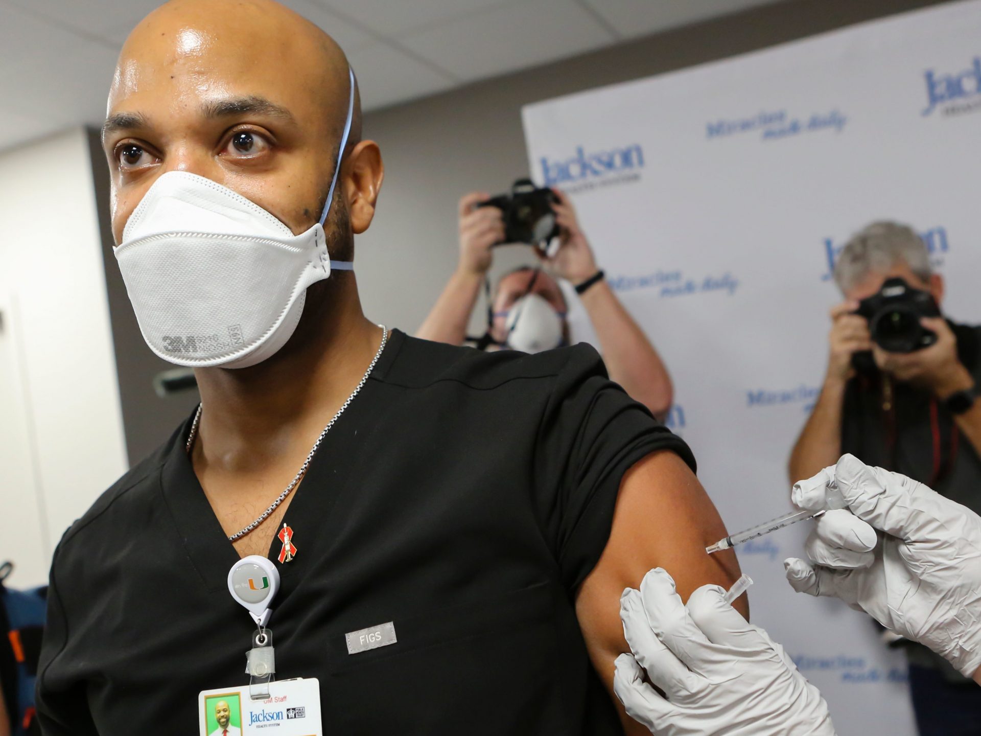 Dr. Hansel Tookes made sure his first dose of Pfizer's COVID-19 vaccine at Jackson Memorial Hospital in Miami on Dec. 15. was televised, as a way to combat hesitancy.