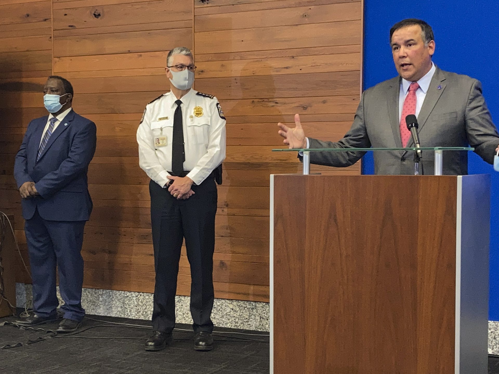 Columbus Mayor Andrew Ginther, right, speaks during a news conference, Wednesday, April 21, 2021, about the Tuesday fatal police shooting of 16-year-old Ma'Khia Bryant, as she swung a knife at two other people in Columbus, Ohio. Ginther said the entire community bears responsibility for Ma'Khia's death. Columbus Public Safety Director Ned Pettus Jr., left, and interim Police Chief Michael Woods, center, listen.