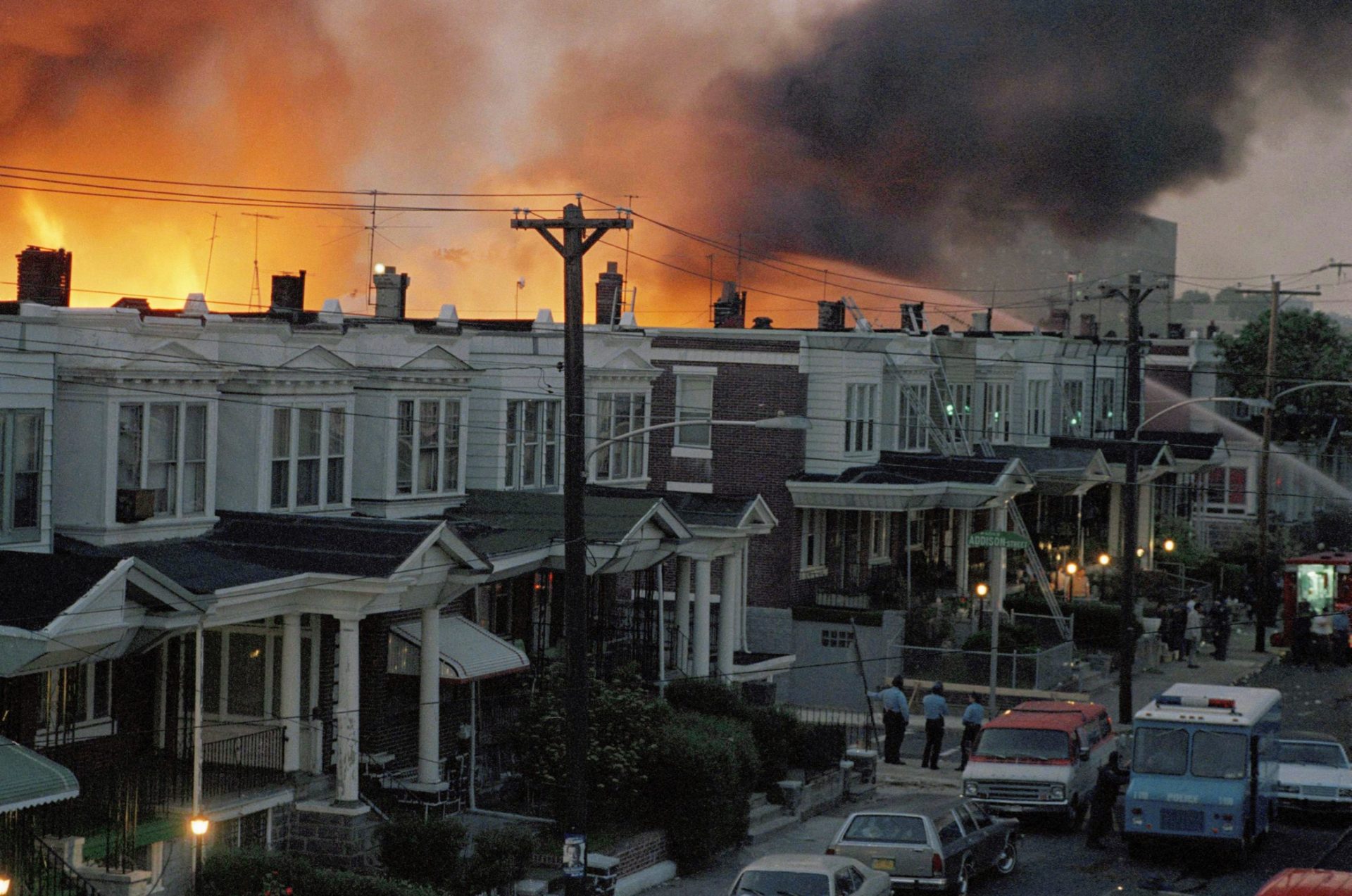 FILE PHOTO: In this file photo, scores of West Philly rowhouses burn in a fire after police dropped a bomb on the MOVE headquarters on May 13, 1985. Eleven people were killed, including five children.