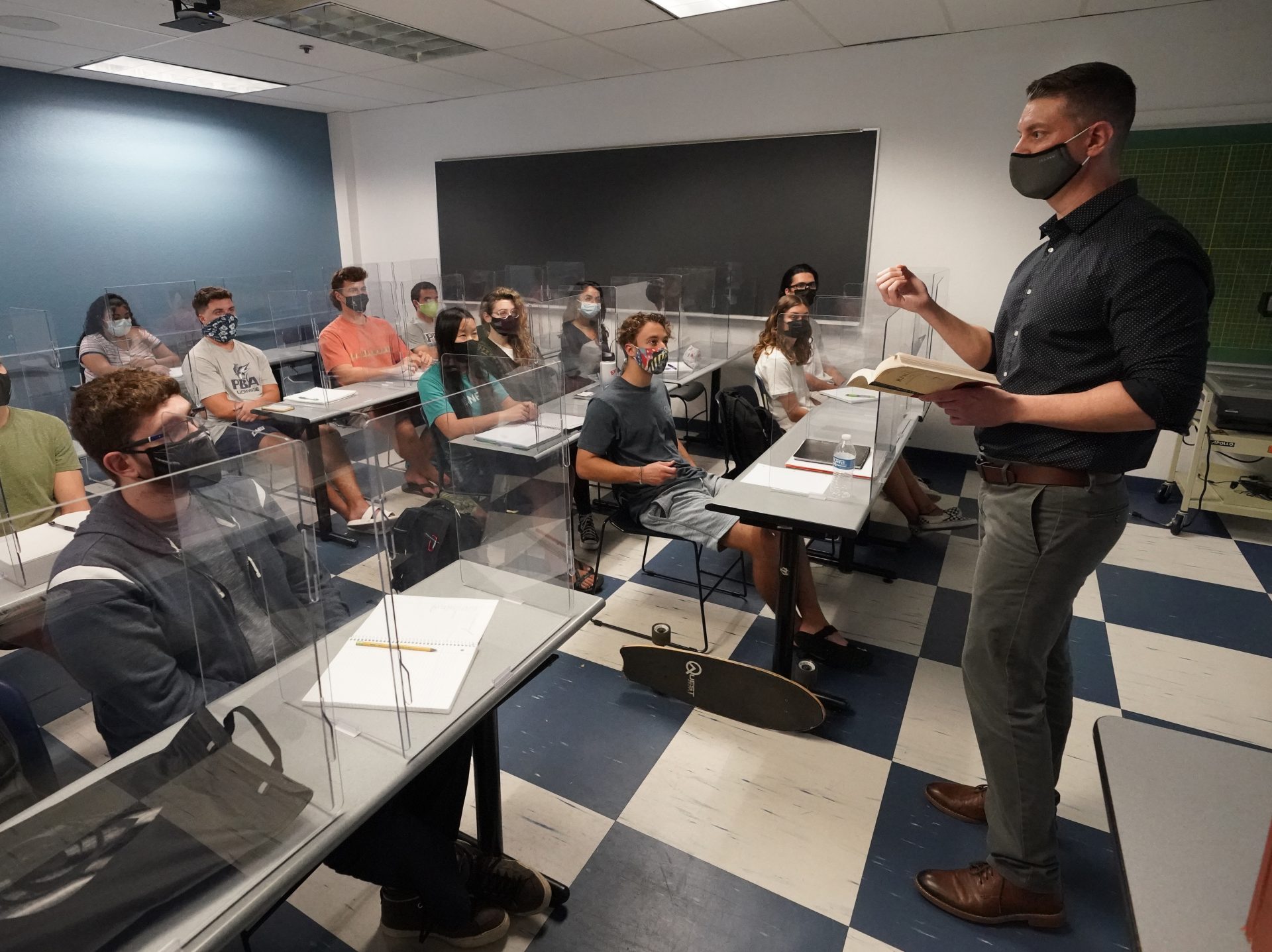 The CDC announced Thursday that fully vaccinated people can safely stop wearing masks indoors. Kyle Faircloth, Associate Professor of Intercultural Studies, is seen teaching a class at Palm Beach Atlantic University in West Palm Beach, Fla., in February 2021.