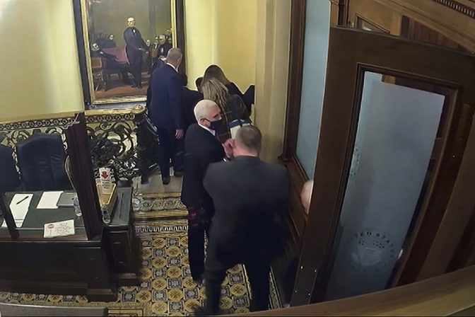 In this image from video, a security video shows Vice President Mike Pence being evacuated from near the Senate chamber as rioters breach the Capitol, on Jan. 6, 2021, at the Capitol in Washington.