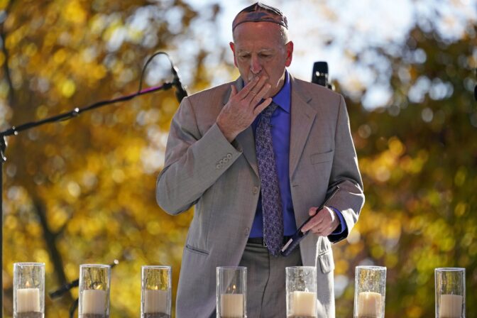 A candle is lit in memory of Jerry Rabinowitz, one of 11 worshippers killed four years ago when a gunman opened fire at the Tree of Life synagogue in the Squirrel Hill neighborhood of Pittsburgh, during a Commemoration Ceremony in Pittsburgh on Thursday, Oct. 27, 2022.