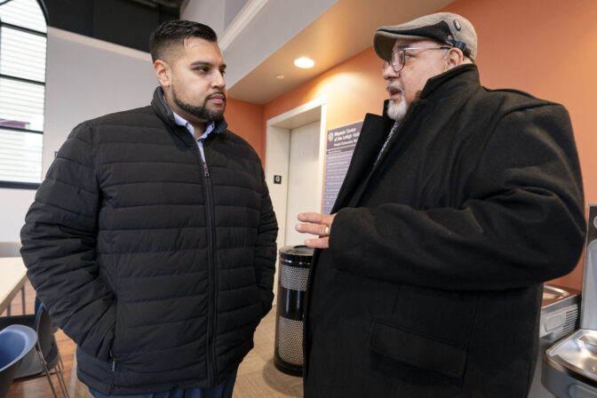 Guillermo Lopez Jr., right, talks with Raymond Santiago, executive director, Hispanic Center Lehigh Valley, left, after being interviewed, Thursday, Jan. 18, 2024, in Bethlehem, Penn. President Joe Biden is warning that Donald Trump will be a grave threat to American democracy if he wins re-election, but interviews with Pennsylvania voters again suggest it's not resonating. Lopez says about voters, "their concern is finding steady work with good pay." (AP Photo/Chris Szagola)