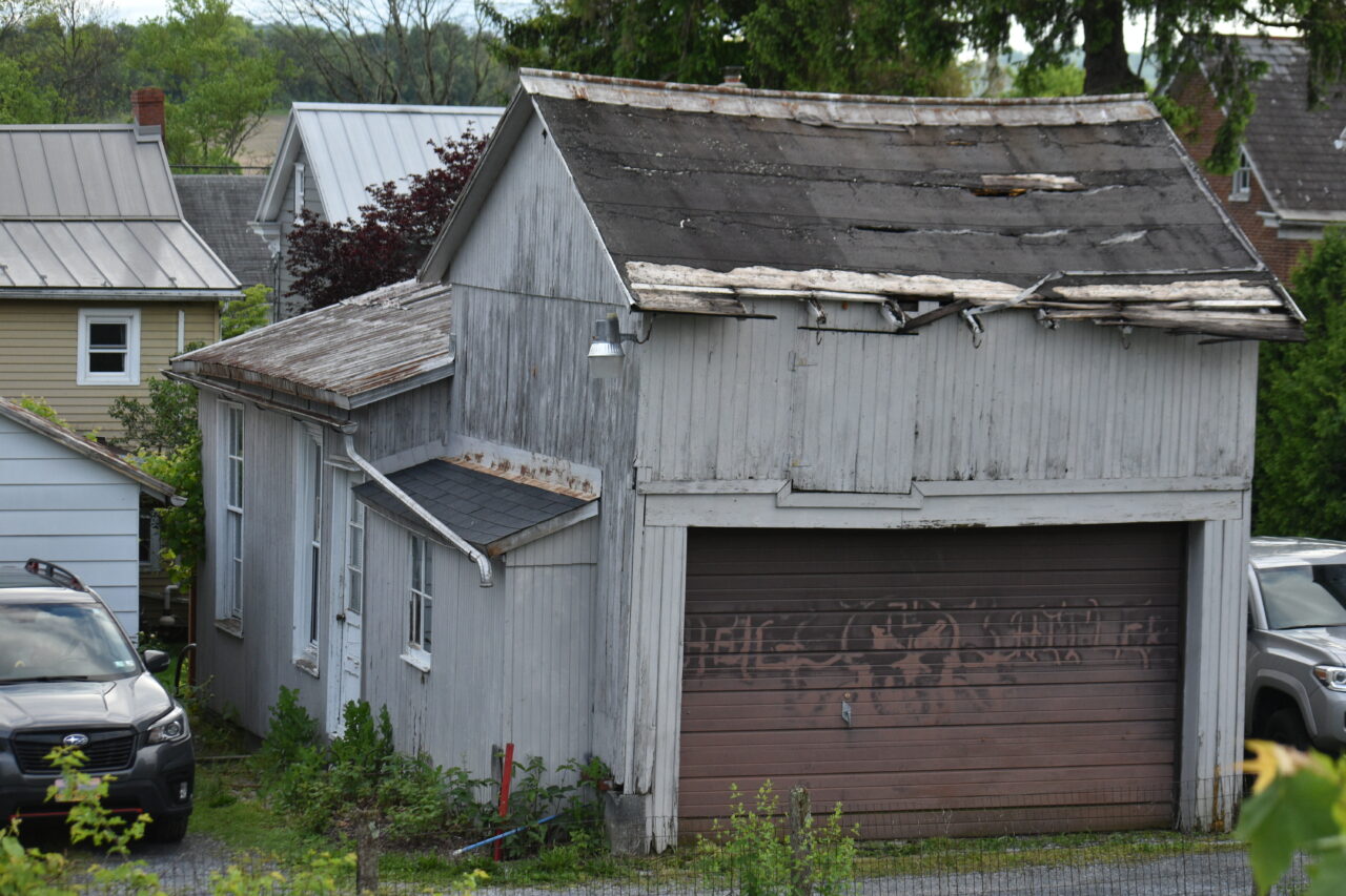 A garage belonging to Christina Moyer, according to county property records, saying "Heil Hitler" in faded paint. The property abuts Oley Valley High School's parking lot. The words have since been painted over. Pictured on May 15, 2024.