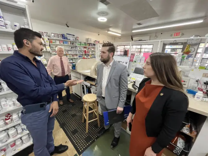 Allentown Pharmacy owner Nik Patel, left, talks with state Reps. Joshua Siegel and Jessica Benham as state Rep. Steve Samuelson listens. Benham is the sponsor of House Bill 1993, which she says would help community pharmacies stay afloat and lower the cost of prescription drugs for patients by limiting or banning certain practices by pharmacy benefit managers. Patel said he has had to put $50,000 from his own pocket into the business since January to stay afloat amid rising costs. Without some relief, Patel said the outlook is bleak. 'Probably we won't survive the next two years,' he said.