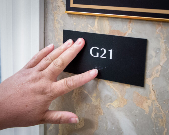 Pam Auer, director of advocacy at Center for Independent Living of Central Pennsylvania, points out braille letters inside the North Office Building In the Pennsylvania Capitol complex in Harrisburg Tuesday, June 4, 2024.