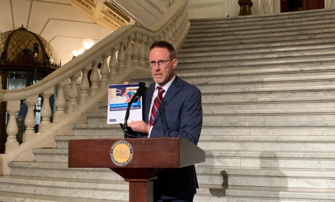 David Masur, executive director of PennEnvironment, holds up a report on lead testing in Pa. school districts on Sept. 4, 2024. 