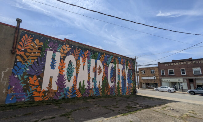 A mural along Main Street in Homer City on Sept. 16, 2024. Blighted buildings across the street would be removed to make way for a new community hub under the revitalization plan. (Jeremy Long - WITF)