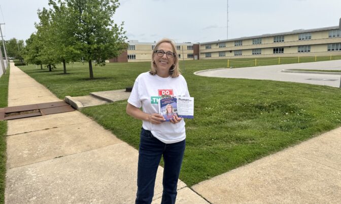 Eden Durbin, a volunteer canvassing for Janelle Stelson, stands in front of a high school in a York County, Pennsylvania, neighborhood.
