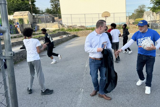 Justin Douglas prepares to play basketball with kids at the Scott Elementary School playground in Harrisburg, Pa.'s Allison Hill neighborhood on May 13, 2026.