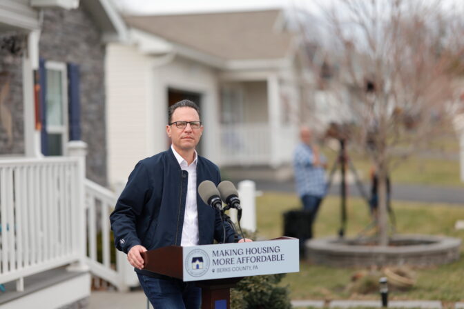 Gov. Josh Shapiro stands behind a podium that says “Making Housing More Affordable.”